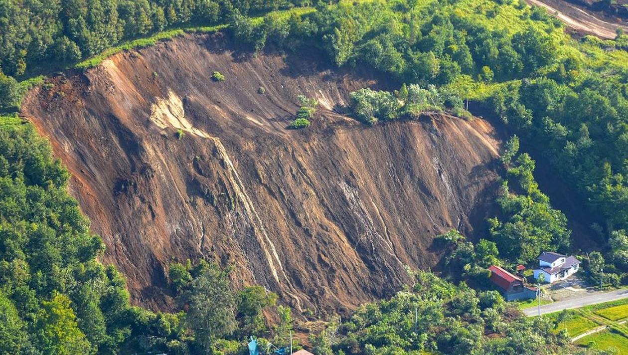 This picture shows an aerial view of houses damaged by a landslide in Atsuma town, Hokkaido prefecture on September 6, 2018, after an earthquake hit the northern Japanese island of Hokkaido.
A powerful 6.6 magnitude quake hit the northern Japanese island of Hokkaido on September 6, triggering landslides, bringing down several houses, and killing at least one person with several dozen missing. / AFP PHOTO / JIJI PRESS / JIJI PRESS / Japan OUT