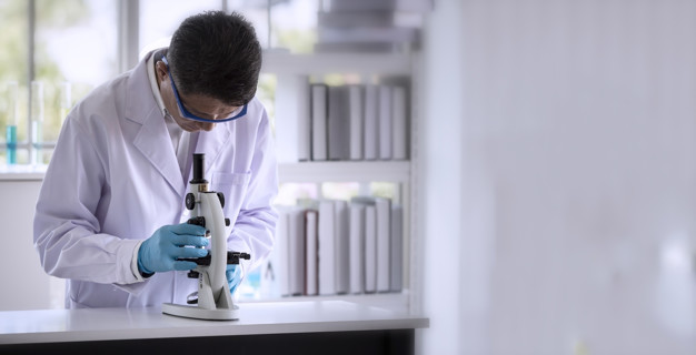 Laboratory concept: Scientist researching by microscopy technique in laboratory with copy space.