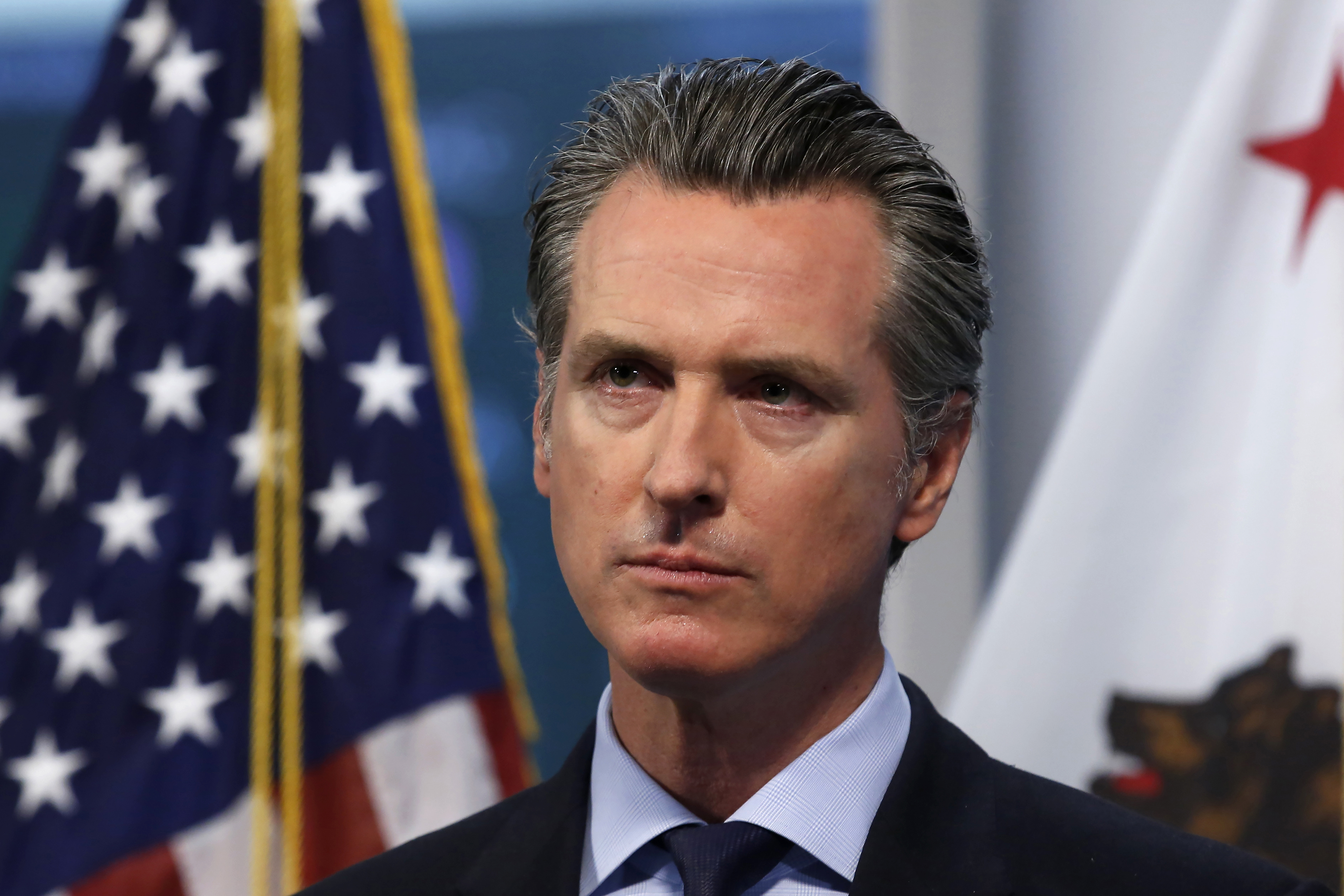 FILE - In this April 9, 2020, file photo, California Gov. Gavin Newsom listens to a reporter's question during his daily news briefing in Rancho Cordova, Calif. At his briefing Friday, May 29, 2020, Newsom gave a powerful statement on the death of George Floyd at the hands of police in Minneapolis. Newsom recounted how the death of Floyd in police custody in Minnesota impacted his four young children. Newsom said his kids broke down and cried as they struggled to understand how 