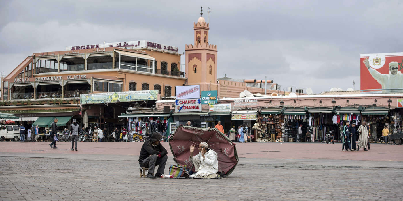 workers of the Jamaa El Fna place sits on March 16, 2020 in the city of Marrakesh