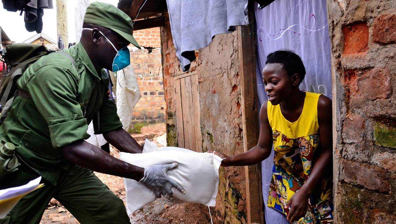 A civilian receives relief food during a government distribution exercise to civilians affected by the lockdown, as part of measures to prevent the potential spread of coronavirus disease (COVID-19), in Kampala, Uganda April 4, 2020. REUTERS/Abubaker Lubowa