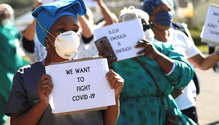 Health care workers holding signs, protest over the lack of personal protective equipment (PPE) during the coronavirus disease (COVID19) outbreak, outside a hospital in Cape Town, South Africa, June 19, 2020. REUTERS/Mike Hutchings - RC2BCH99EL84